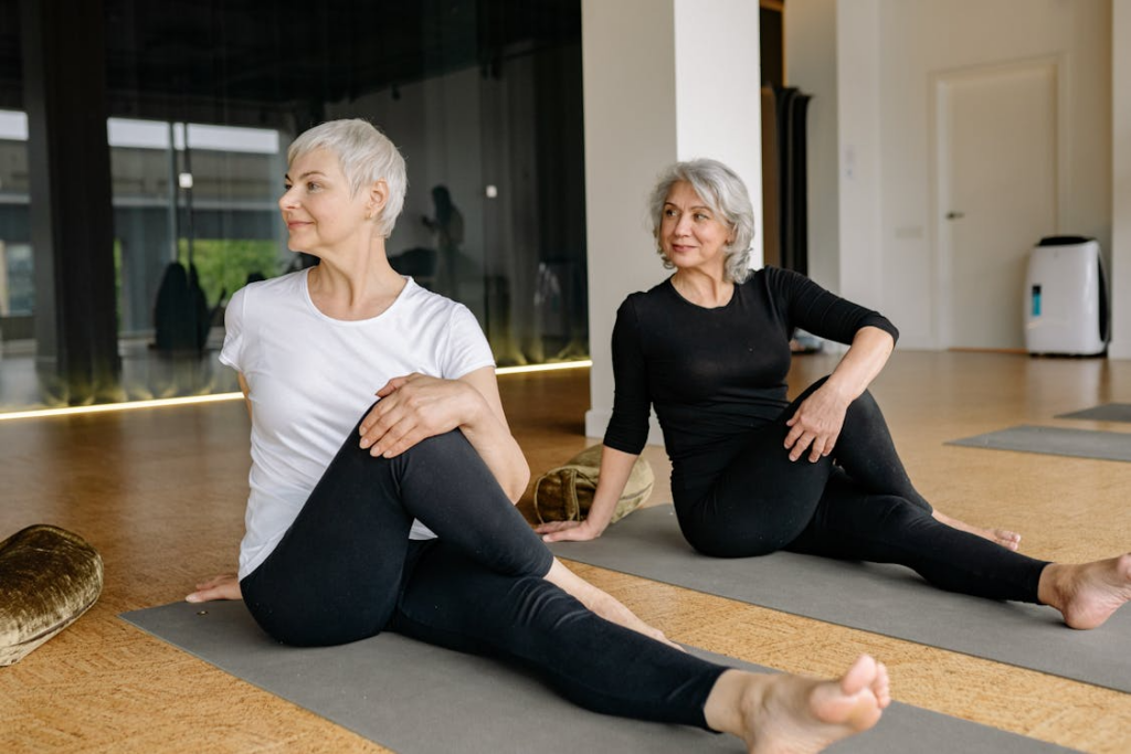 Two women stretching on yoga mats