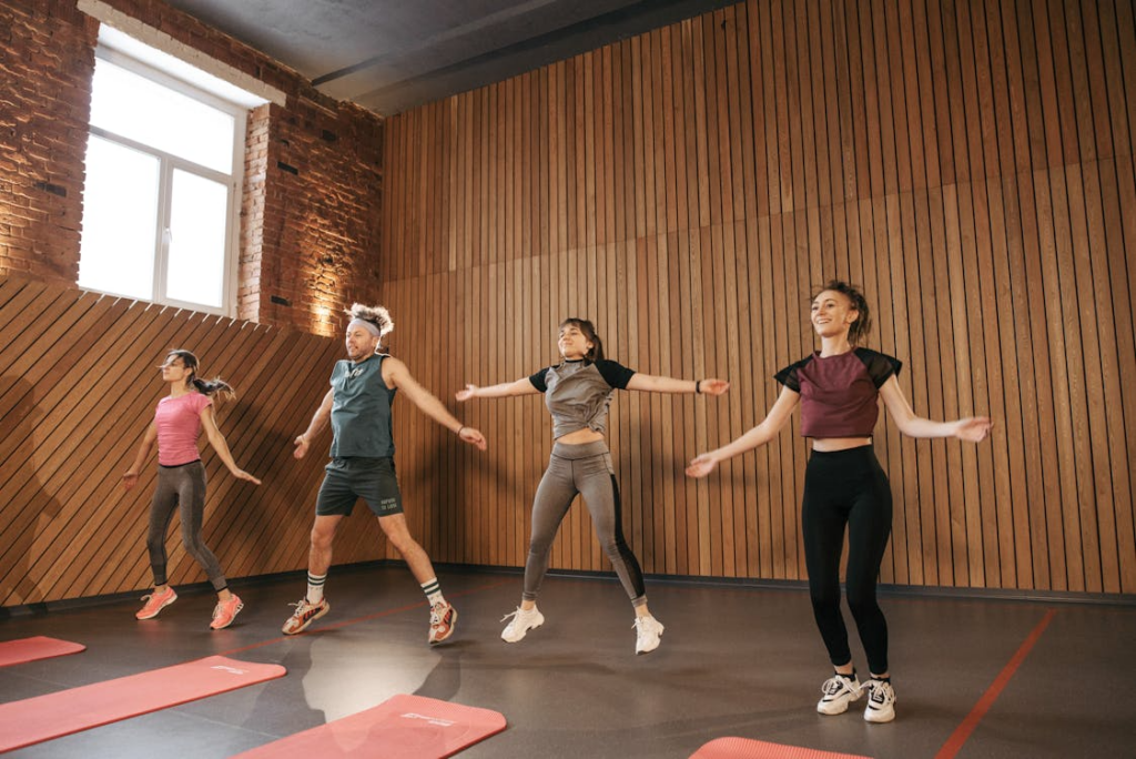 Active adults stretching after a workout in a modern gym setting
