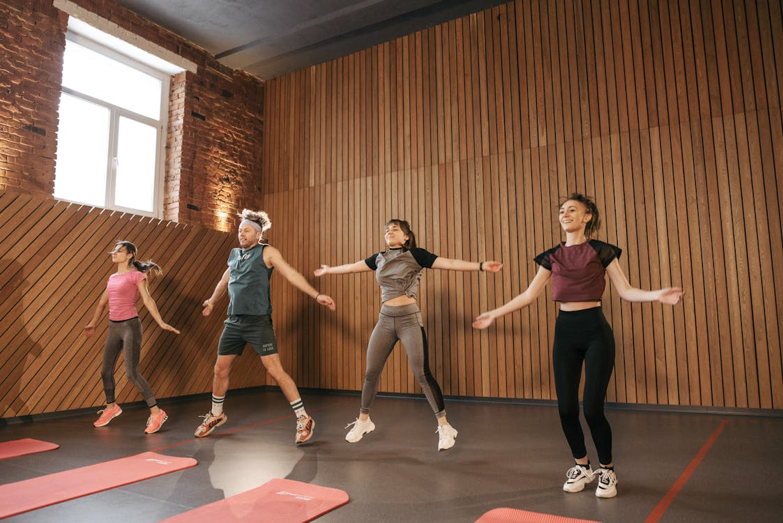 Active adults stretching after a workout in a modern gym setting