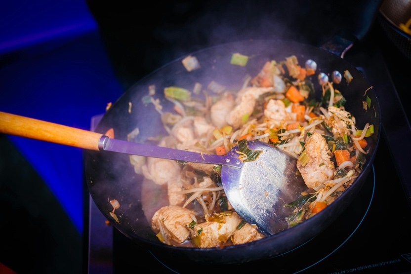 Adult preparing a healthy meal with lean protein and vegetables