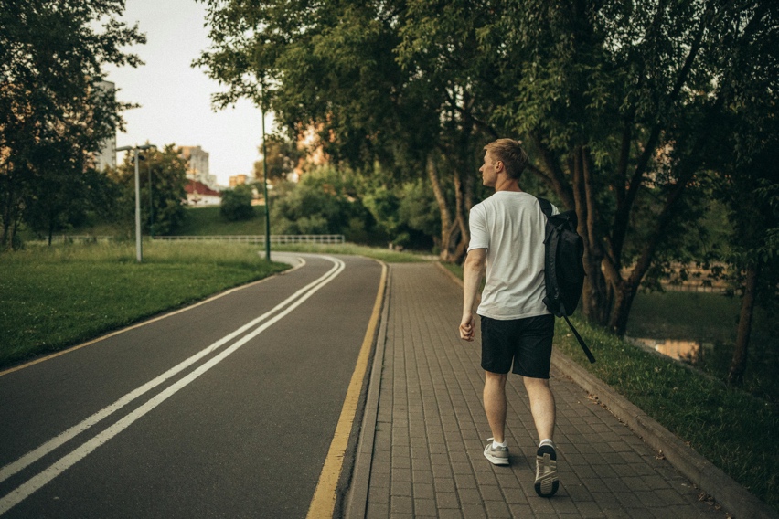 Adult walking outdoors with a relaxed and energized posture