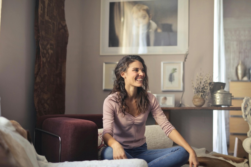 Adult sitting calmly in a bright indoor space with a relaxed expression