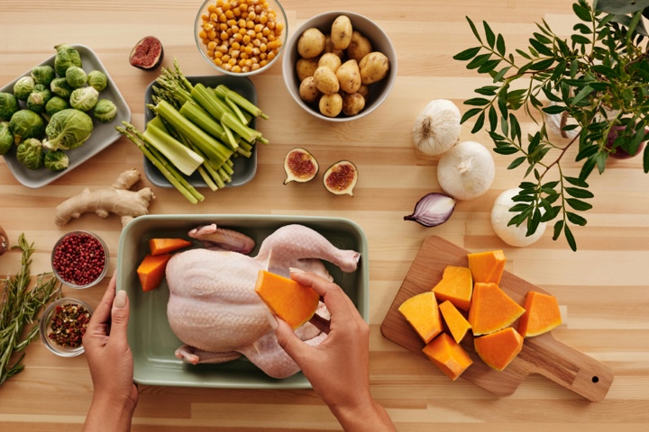  Adult preparing a meal with lean protein and fresh vegetables
