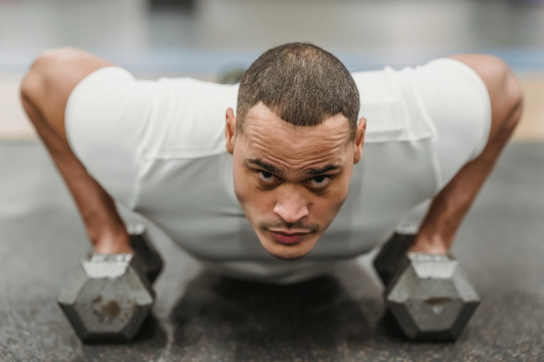 Adult exercising in a gym with focused effort and good form