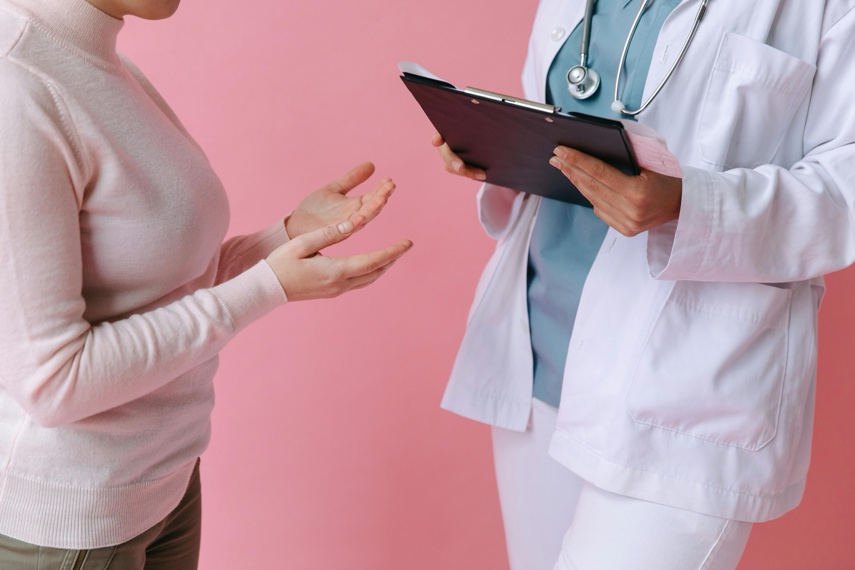 Adult speaking with a healthcare professional in a clean clinical setting
