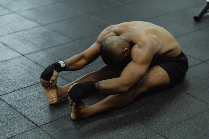 Adult stretching after a workout in a gym environment