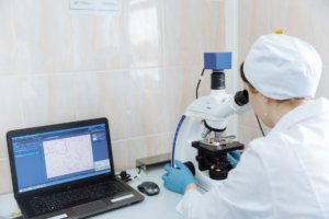 a scientist examining a digital cell structure in a lab