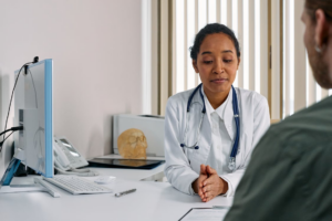 a patient in conversation with a healthcare provider at a desk