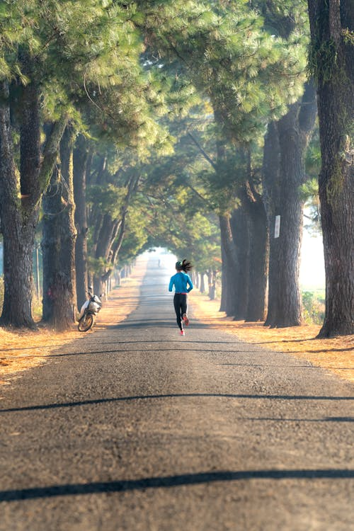 a woman jogging on a trail in the morning