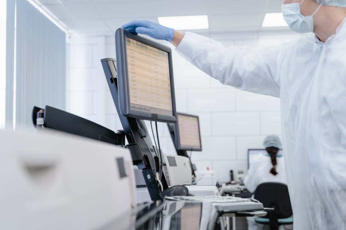 a researcher reviewing results on a computer screen in a clinical setting