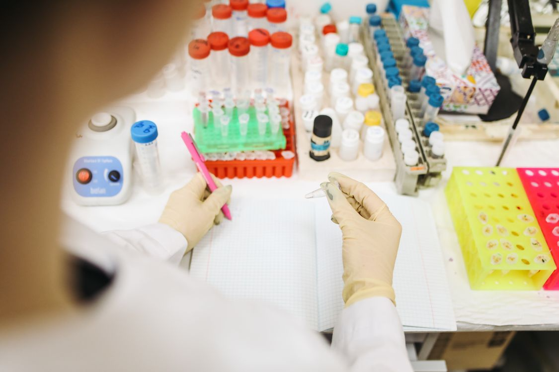 close-up of a scientist examining vials in a research laboratory