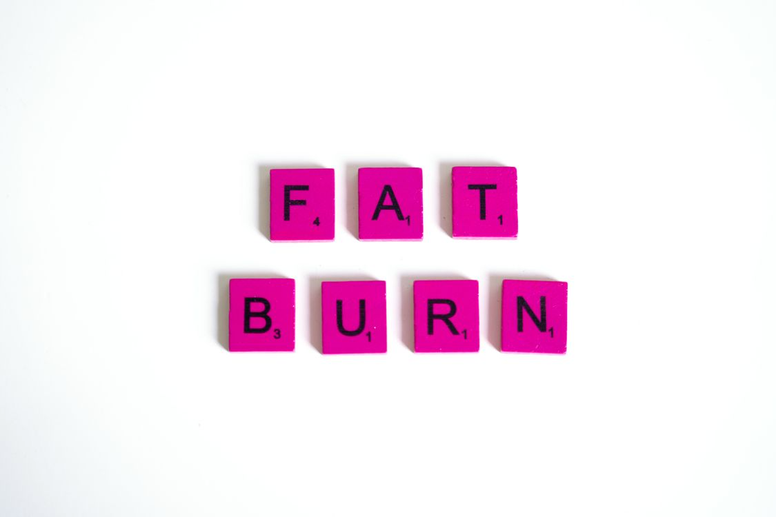 The words "fat burn" spelled out in pink letter tiles on a white background